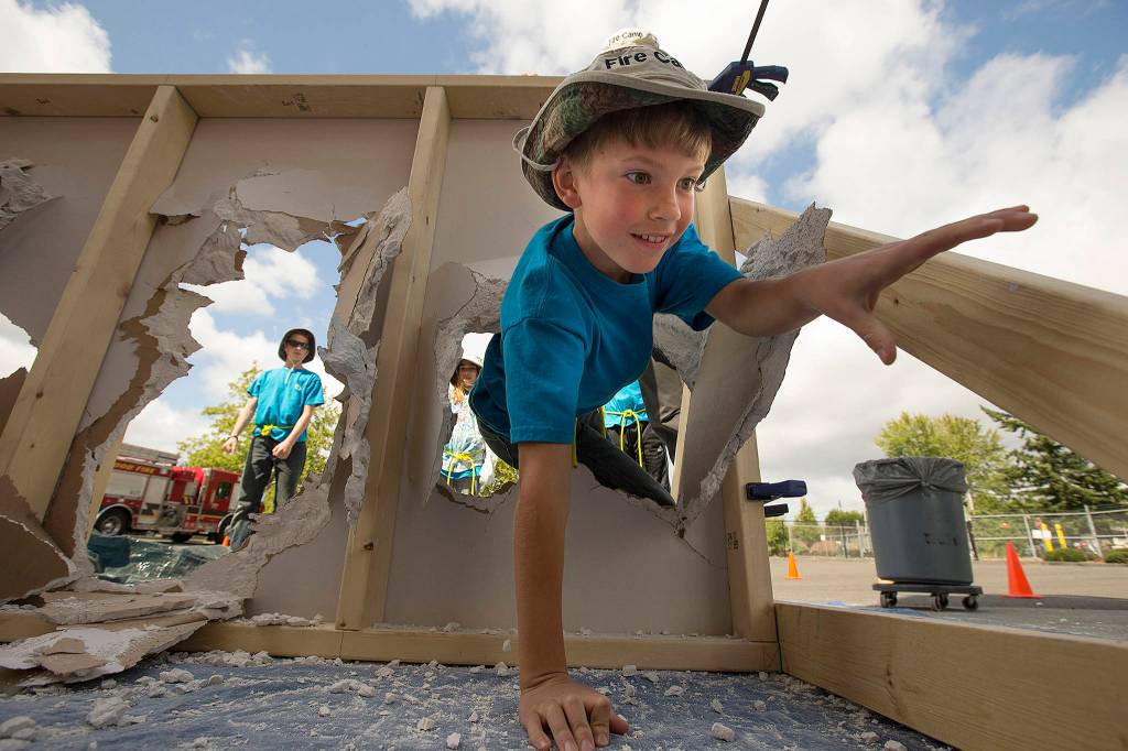 Isaac Williams of Lynnwood, 11, practices escape methods during the Kids Fire Camp hosted by Fire District 1 on July 20 in Lynnwood. (Andy Bronson / The Herald)
