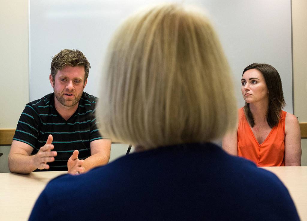 Senator Patty Murray listens as recovering addicts Army veteran Daniel Veach and mother Rachel Weaver (right) talk about the need for Medicaid to continue their recovery at the Community Health Center of Snohomish County on Thursday in Everett. (Andy Bronson / The Herald)