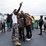French-speaking visitors take a selfie together aboard a ferry on the Mukilteo/Clinton run on June 21. (Andy Bronson / The Herald)