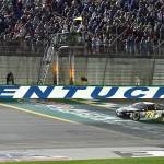 Martin Truex Jr. crosses the finish line first to win the NASCAR Cup race at Kentucky Speedway on Saturday in Sparta, Kentucky. (AP Photo/Timothy D. Easley)