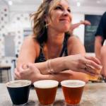 Megan Eison is ready to enjoy her four sample microbrews at Scrappy Punk Brewery during the inaugural Soho Brew Tour in Snohomish on June 24. (Kevin Clark / The Herald)