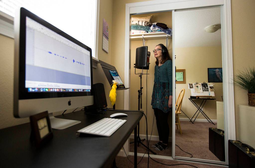 Voice artist Saacha K. Belgar uses her closet as a recording studio May 24 in Snohomish. (Andy Bronson / The Herald)