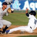 Everett&rsquo;s Evan White beats the tag attempt by Tri-City&rsquo;s Justin Lopez Wednesday night at Everett Memorial Stadium. (Kevin Clark / The Herald)