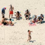 New Jersey Gov. Chris Christie (right) uses the beach with his family and friends at the governor&rsquo;s summer house at Island Beach State Park in New Jersey on Sunday. Christie is defending his use of the beach, closed to the public during New Jersey&rsquo;s government shutdown. (Andrew Mills/NJ Advance Media via AP)