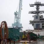 The island tower of the USS Gerald R. Ford aircraft carrier stands amid construction equipment during outfitting and testing at Huntington Ingalls Industries&rsquo; Newport News Shipbuilding shipyard in Newport News, Virginia, in 2014. (Andrew Harrer/Bloomberg)