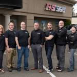Clear Image Frame and Photo owner Daniel Jolly, center, purchased the Everett franchise of FastSigns earlier this year. He plans to move the business to downtown Everett this summer. (Contributed photo)