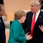 U.S. President Donald Trump gestures as he talks to German Chancellor Angela Merkel and European Council President Donald Tusk during a working session at the G-20 summit in Hamburg, northern Germany, on Saturday. (AP Photo/Michael Sohn)