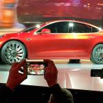 Tesla Motors unveils the new lower-priced Model 3 sedan at the Tesla Motors design studio in Hawthorne, California, in March. (AP Photo/Justin Pritchard, File)