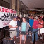 Gerald Winchester, left, chats with Marie Marine, right, as they wait to enter the former Trump Taj Mahal casino in Atlantic City N.J. on Thursday July 6, 2017 for a sale of the casino hotel&rsquo;s contents. Included in the items for sale were crystal chandeliers from Austria that now-President Donald Trump bought for the casino when he opened it in 1990. The casino shut down last year under different ownership. (AP Photo/Wayne Parry)