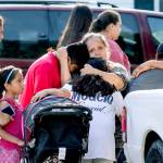 Neighbors stand outside near a home where police say multiple people were found dead, Thursday, in Loganville, Georgia, east of Atlanta. (John Spink/Atlanta Journal-Constitution via AP)