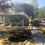Crews douse a house fire south of Everett on Saturday. (Snohomish County Fire District 1)