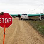 In this 2016 photo, a crew member stops traffic as work resumed on the four-state Dakota Access pipeline near St. Anthony, North Dakota. (AP Photo/Blake Nicholson, File)