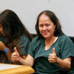 Isabel Martinez gestures towards news cameras during her first court appearance Friday in Lawrenceville, Georgia. Martinez is charged with killing four of her children and their father. (AP Photo/John Bazemore)