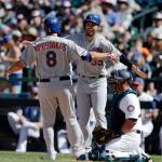 The Royals&rsquo; Mike Moustakas is greeted at home by Eric Hosmer after hitting a home run during the fourth inning of a game July 4, 2017, in Seattle. Mariners catcher Carlos Ruiz kneels on the ground. (AP Photo/John Froschauer)