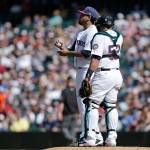 Mariners starting pitcher Felix Hernandez talks with catcher Carlos Ruiz after giving up a home run against the Royals during a game on July 4, 2017, in Seattle. (AP Photo/John Froschauer)