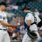 Mariners starting pitcher Sam Gaviglio (left) is pulled from the game against the Athletics during the fifth inning as catcher Mike Zunino stands nearby on July 6, 2017, in Seattle. (AP Photo/Ted S. Warren)