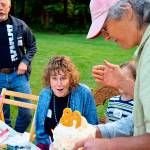 Cary Peterson (right) presents her mother, Meg Noble Peterson, with a birthday cake recently at a Langley neighborhood picnic. Peterson, who just turned 89, is representative of Whidbey Island&rsquo;s ranking as a leader in longevity. (Photos by Patricia Guthrie/Whidbey News-Times)