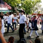 Participants walk along the parade route for the annual An Edmonds Kind of 4th in downtown Edmonds on Tuesday. (Ian Terry / The Herald)