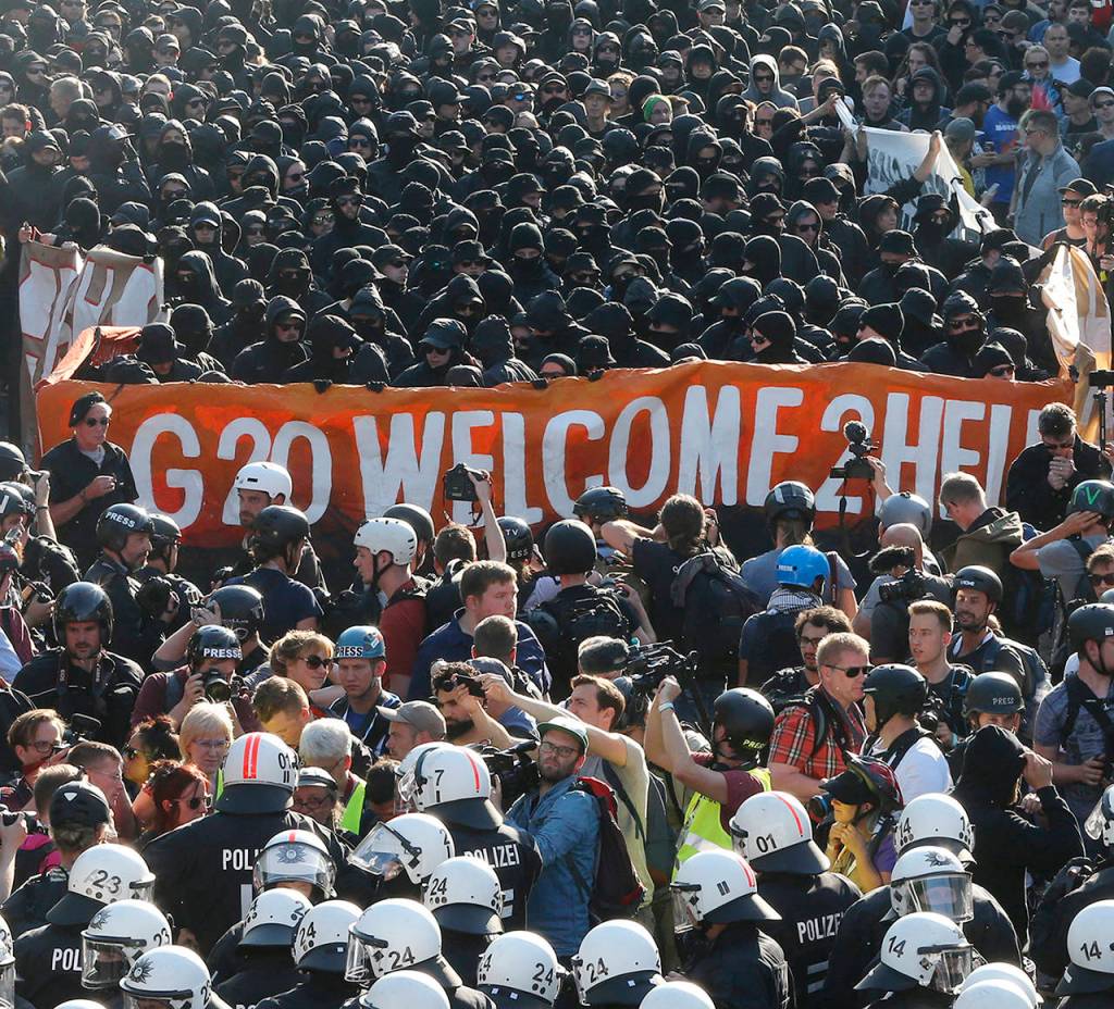 Black dressed demonstrators and police face each other during a protest titled &ldquo;G20 Welcome to hell&rdquo; against the G-20 summit in Hamburg, northern Germany on Thursday. (AP Photo/Michael Probst)
