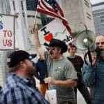 In this Feb. 6, 2017, file photo, supporters and critics of defendants on trial at the federal courthouse gather in Las Vegas. Federal prosecutors will try again to convince a jury that four men conspired with Nevada rancher Cliven Bundy and his family when they took up arms during a 2014 standoff that stopped federal agents from confiscating cows belonging to the states&rsquo; rights advocate. July selection begins Monday, July 10. (AP Photo/John Locher, FIle)