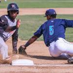 Salem-Keizer&rsquo;s Manuel Geraldo slides safely third base with Everett&rsquo;s Chris Torres attempting a tag into Sunday afternoon at Everett Memorial Stadium in Everett on July 9, 2017. Salem-Keizer won 7-6. (Kevin Clark / The Herald)