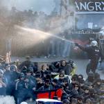 A Police officer sprays a liquid during a protest against the G-20 summit in Hamburg, northern Germany, on Thursday. (AP Photo/Michael Probst)