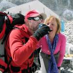 Rick Thurmer and his wife, Allie, celebrate his summit of Mount Everest in 2010, a climb that also involved the rescue of another climber. Allie Thurmer had the beer portered to base camp on a yak. (Rick Thurmer)