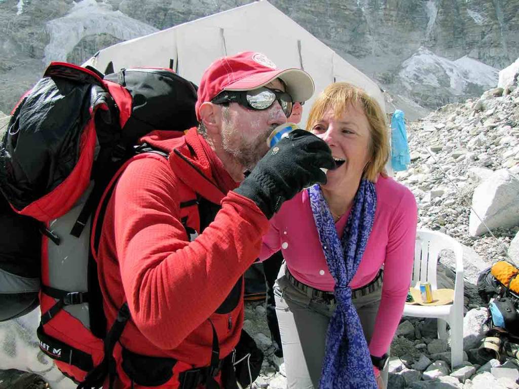 Rick Thurmer and his wife, Allie, celebrate his summit of Mount Everest in 2010, a climb that also involved the rescue of another climber. Allie Thurmer had the beer portered to base camp on a yak. (Rick Thurmer)