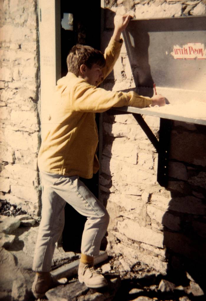 Rick Thurmer, 12, signing the summit register on Mount Whitney, the tallest mountain in the contiguous United States, in 1968. He and his dad completed the 22-mile hike in a day. (Rick Thurmer)