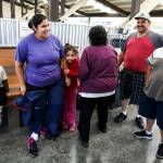 Yessica Ramos (left) is greeted by her family after skydiving at Skydive Snohomish&rsquo;s Fill the Sky with Hope event on Saturday, July 1. (Ian Terry / The Herald)