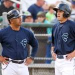 AquaSox manager Jose Moreno (left) talks with Evan White during a game against the Canadians on June 28, 2017, at Everett Memorial Stadium in Everett. (Kevin Clark / The Herald)