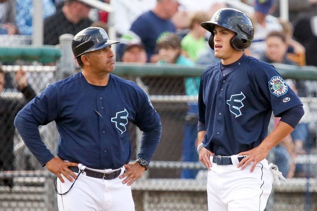 AquaSox manager Jose Moreno (left) talks with Evan White during a game against the Canadians on June 28, 2017, at Everett Memorial Stadium in Everett. (Kevin Clark / The Herald)