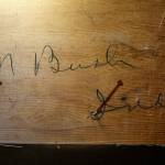 Blair Corson found the signature of Clarence Bush, the original owner of Bush House, when he removed a covering on the lower underside of a hotel staircase. (Dan Bates / The Herald)