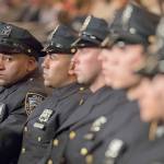Mary Altaffer / Associated Press                                New police in New York City listen to speakers during their graduation Thursday.