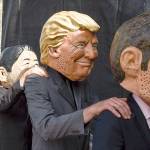 Demonstrators against the G20 Summit stand on stage wearing masks depicting from left : British Prime Minister Theresa May, Japan&rsquo;s Prime Minister Shinzo Abe, US President Donald Trump and French President Emmanuel Macron, in Hamburg, Germany, Sunday. (Axel Heimken/dpa via AP)