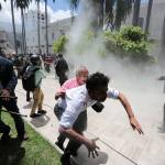 Opposition lawmaker Armando Armas, center front, and National Assembly workers run from pro-government militia members attacking opposition lawmakers and assembly employees during a special session coinciding with Venezuela&rsquo;s independence day, in Caracas, Venezuela, on Wednesday. Pictured right is opposition congressman Simon Calzadilla. (AP Photos/Fernando Llano)