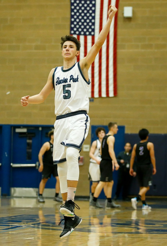 Glacier Peak&rsquo;s Justin Purcell (5) celebrates his team&rsquo;s 62-48 victory over Kamiak on Tuesday at Glacier Peak High School in Snohomish. (Ian Terry / The Herald)