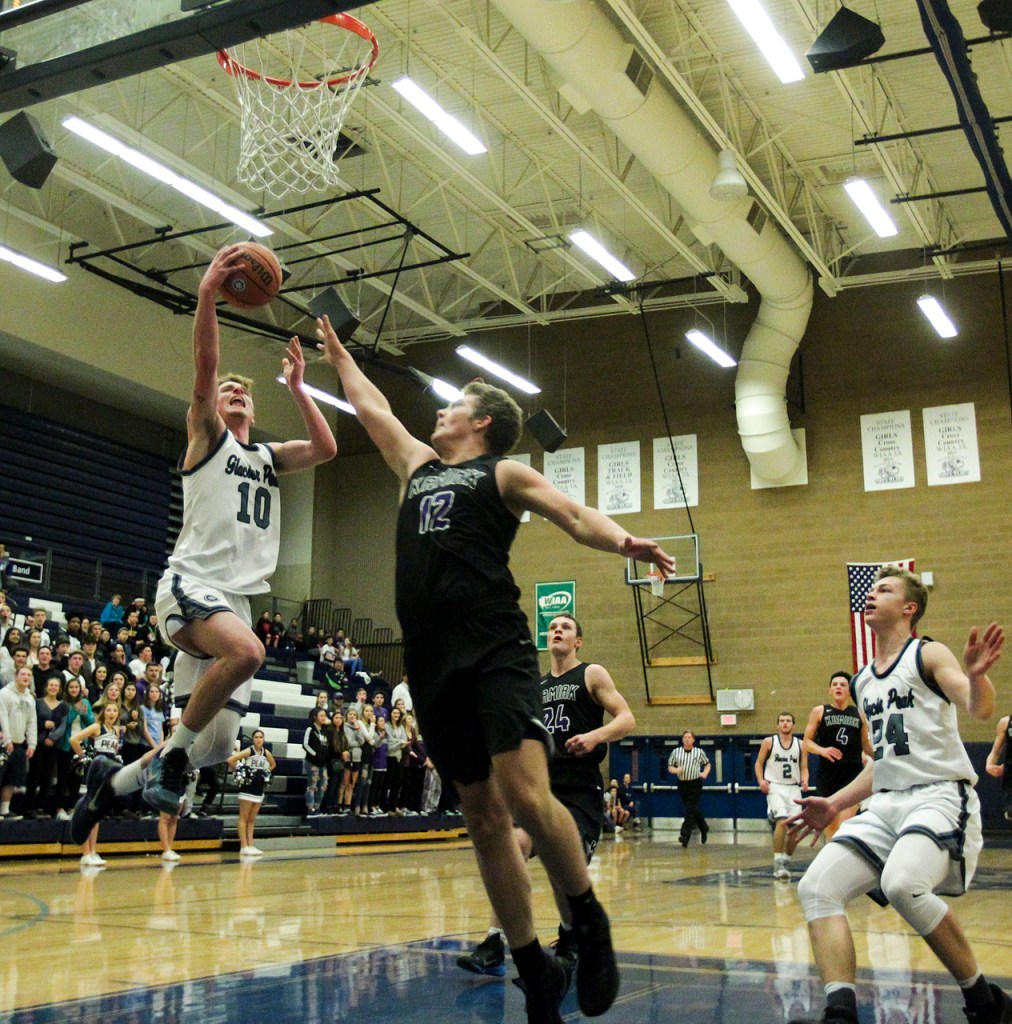 Glacier Peak&rsquo;s Seiver Southard (left) goes up for a layup on a fast break as Kamiak&rsquo;s Landon Overtuff (center) defends during a game Tuesday at Glacier Peak High School in Snohomish. Glacier Peak went on to defeat Kamiak 62-48. (Ian Terry / The Herald)