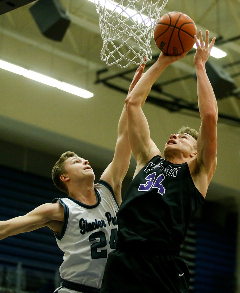 Kamiak&rsquo;s Daniel Sharpe (34) takes a shot as Glacier Peak&rsquo;s Evan Mannes defends during a game Tuesday at Glacier Peak High School in Snohomish. Glacier Peak went on to defeat Kamiak 62-48. (Ian Terry / The Herald)