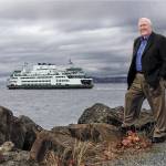 As a ferry heads across the water to Whidbey Island, Larry Hanson pauses along a path just outside the Losvar Condominiums, his home in Mukilteo.(Dan Bates / The Herald)