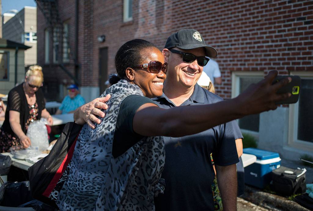 Mayoral candidate Brian Sullivan takes a selfie with Aletha Tatge at a National Night Out event held at Trinity Episcopal Church on Tuesday, Aug. 1, 2017 in Everett, Wa. (Andy Bronson / The Herald)                                Mayoral candidate Brian Sullivan takes a selfie with Aletha Tatge at a National Night Out event at Trinity Episcopal Church on Tuesday in Everett. (Andy Bronson / The Herald)