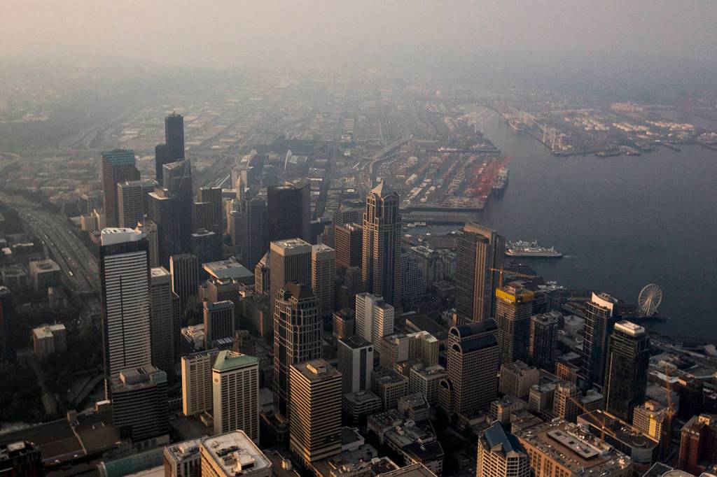 Hazy air, caused by smoke from wildfires blowing south from British Columbia, blankets downtown Seattle early Thursday morning on Aug. 3. (Ian Terry / The Herald)