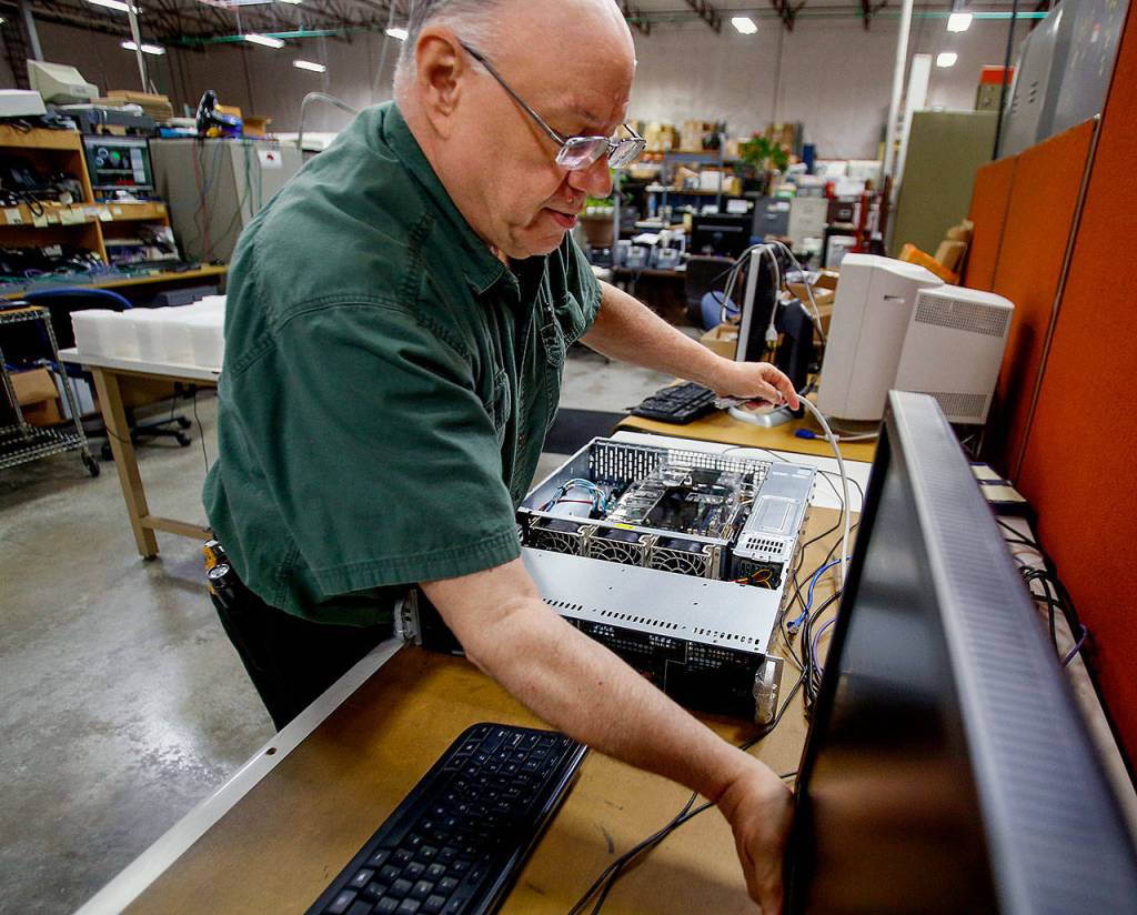 Teo Technologies electronic technician Dave Wright works on a server at the company&rsquo;s spacious manufacturing facility in Mukilteo. (Dan Bates / The Herald)