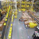 Employees work at the Amazon fulfillment center in Robbinsville Township, New Jersey. Amazon is holding a giant job fair Wednesday and plans to make thousands of job offers on the spot at nearly a dozen U.S. warehouses. (AP Photo/Julio Cortez)