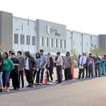 Applicants wait in line to enter a job fair Wednesday at an Amazon fulfillment center in Kent. (AP Photo/Elaine Thompson)