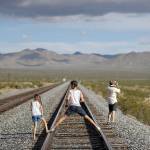 A family walks along train tracks in Nipton, Calif. (AP Photo/John Locher)
