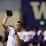 Washington quarterback K.J. Carta-Samuels throws at a July 31 practice session in Seattle. (AP Photo/Elaine Thompson)