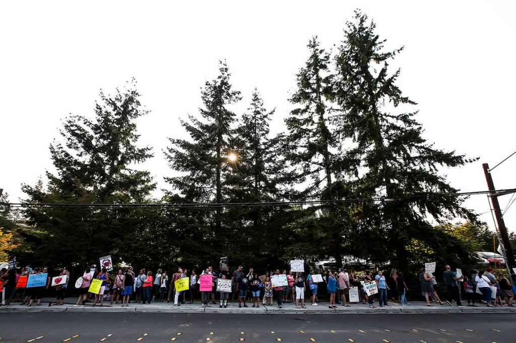 Teachers and parents gather for a rally outside Edmonds School District offices Tuesday evening to highlight ongoing struggles with contract negotiations. (Ian Terry / The Herald)