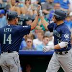 The Mariners&rsquo; Danny Valencia (left) celebrates with third base coach Manny Acta (14) after hitting a two-run home run during the first inning in Game 1 of a doubleheader against the Royals on Aug. 6, 2017, in Kansas City, Mo. (AP Photo/Charlie Riedel)