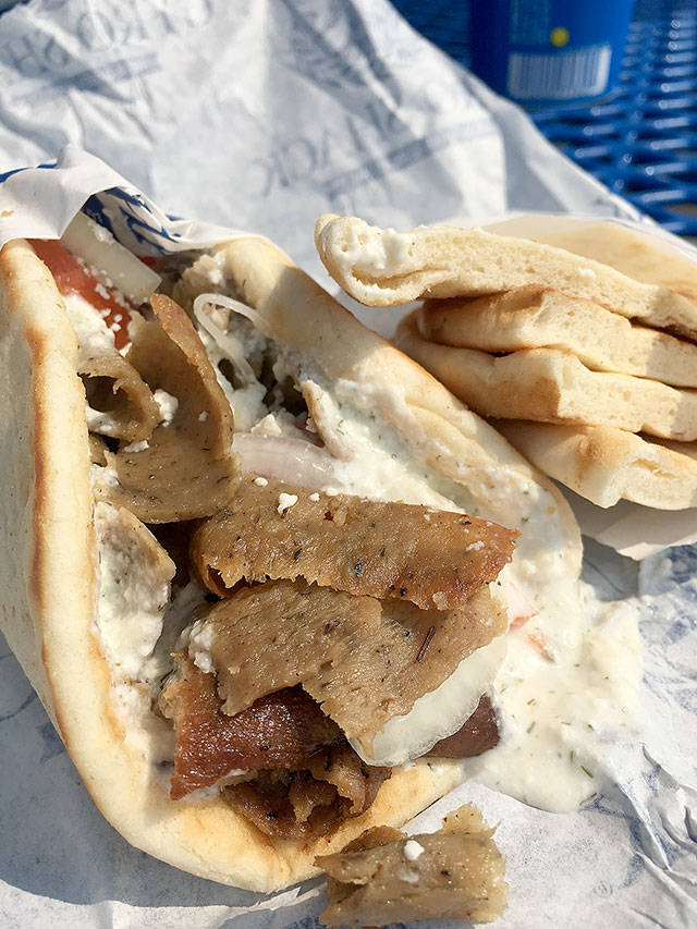 Gyro Shack&rsquo;s Deluxe gyro with gyro meat, an 80/20 percent beef/lamb mix of seasoned and spiced meats with tzatziki sauce, onions and feta cheese, with a combo addition of pita bread and more tzatziki sauce. (Ben Watanabe / The Herald)